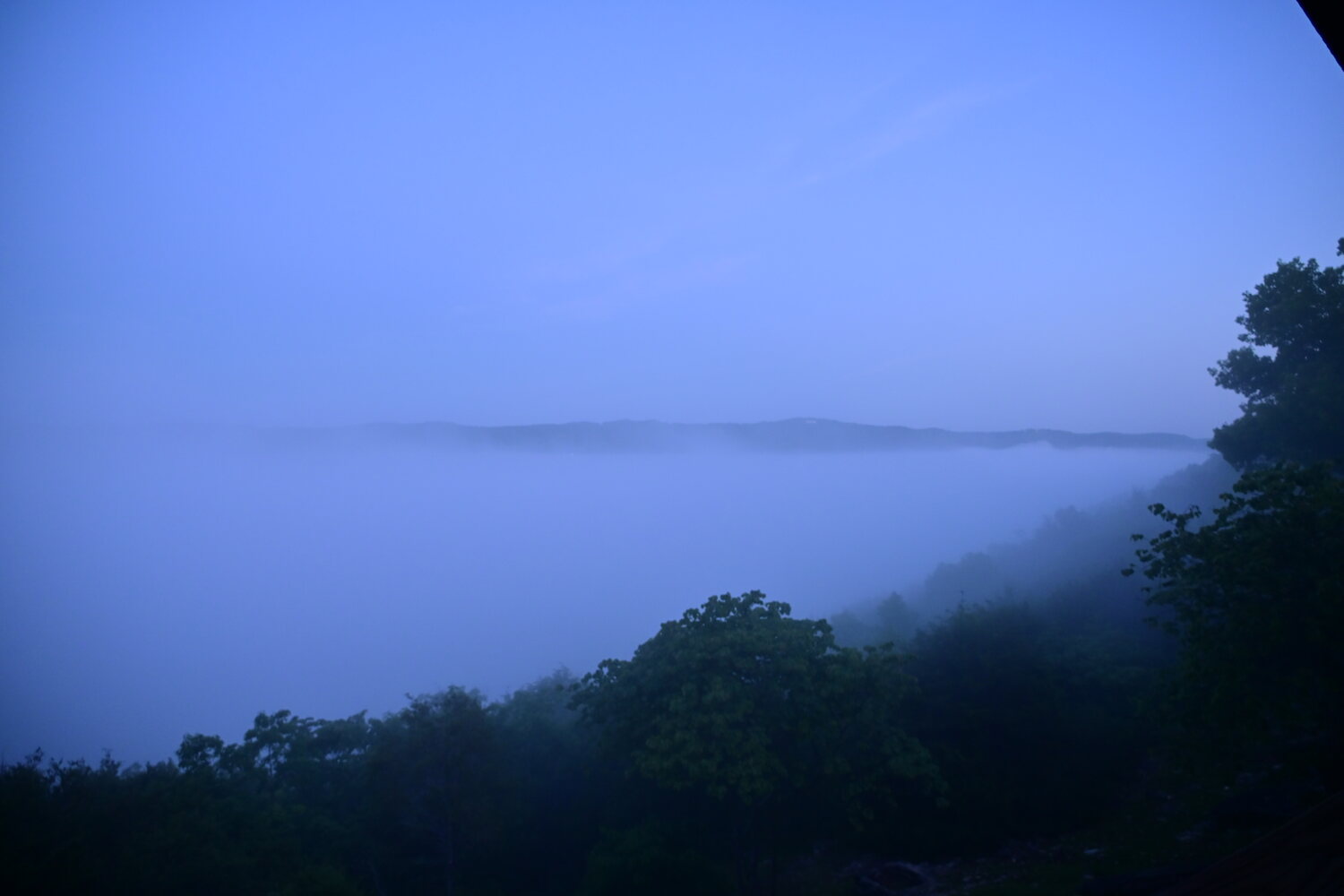 Cool blue early-morning light over fog settling into the White River valley