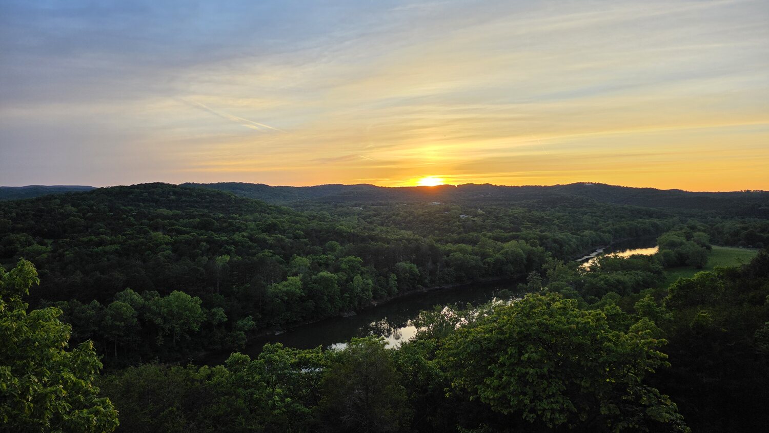 Warm golden sunset over the forested White River valley
