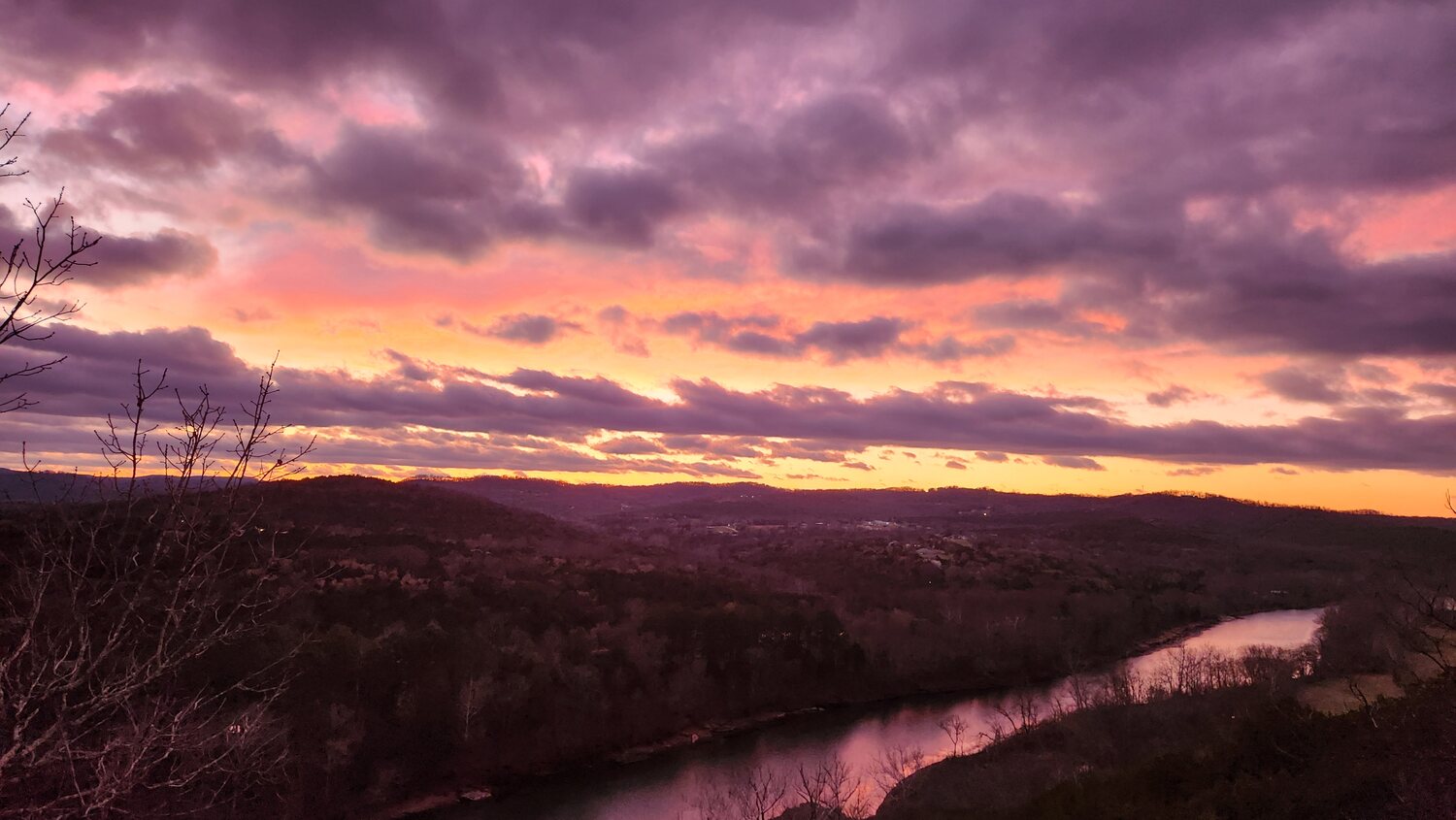 Purple and gold sunset over the White River valley, seen from the cliff-edge cabins near Eureka Springs, Arkansas
